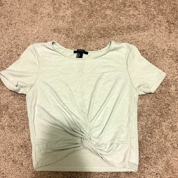 Small, mint green crop top with a scrunched knot in the front. - Picture 1 of 2